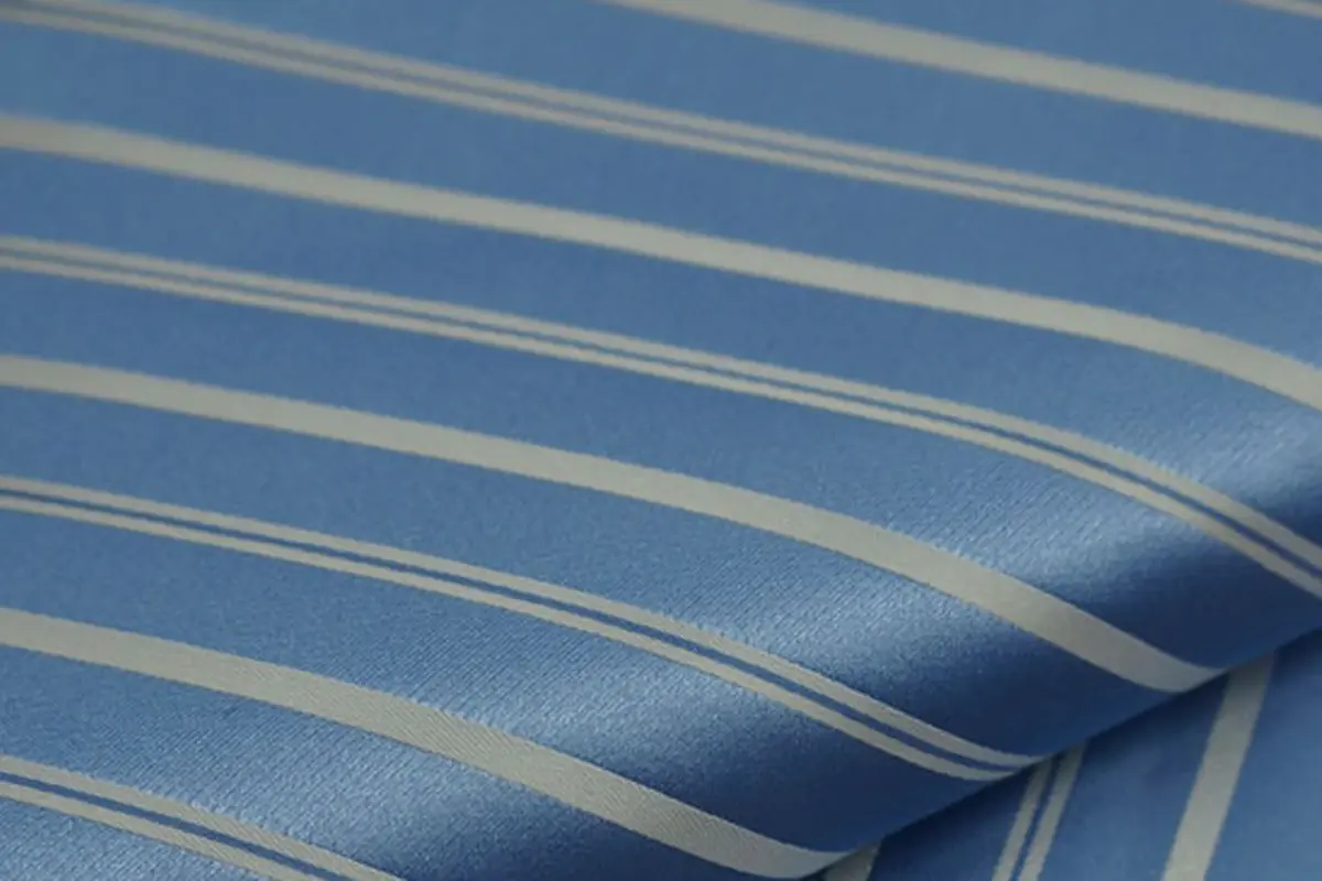 Close-up of blue tie fabric with fine gold stripes
