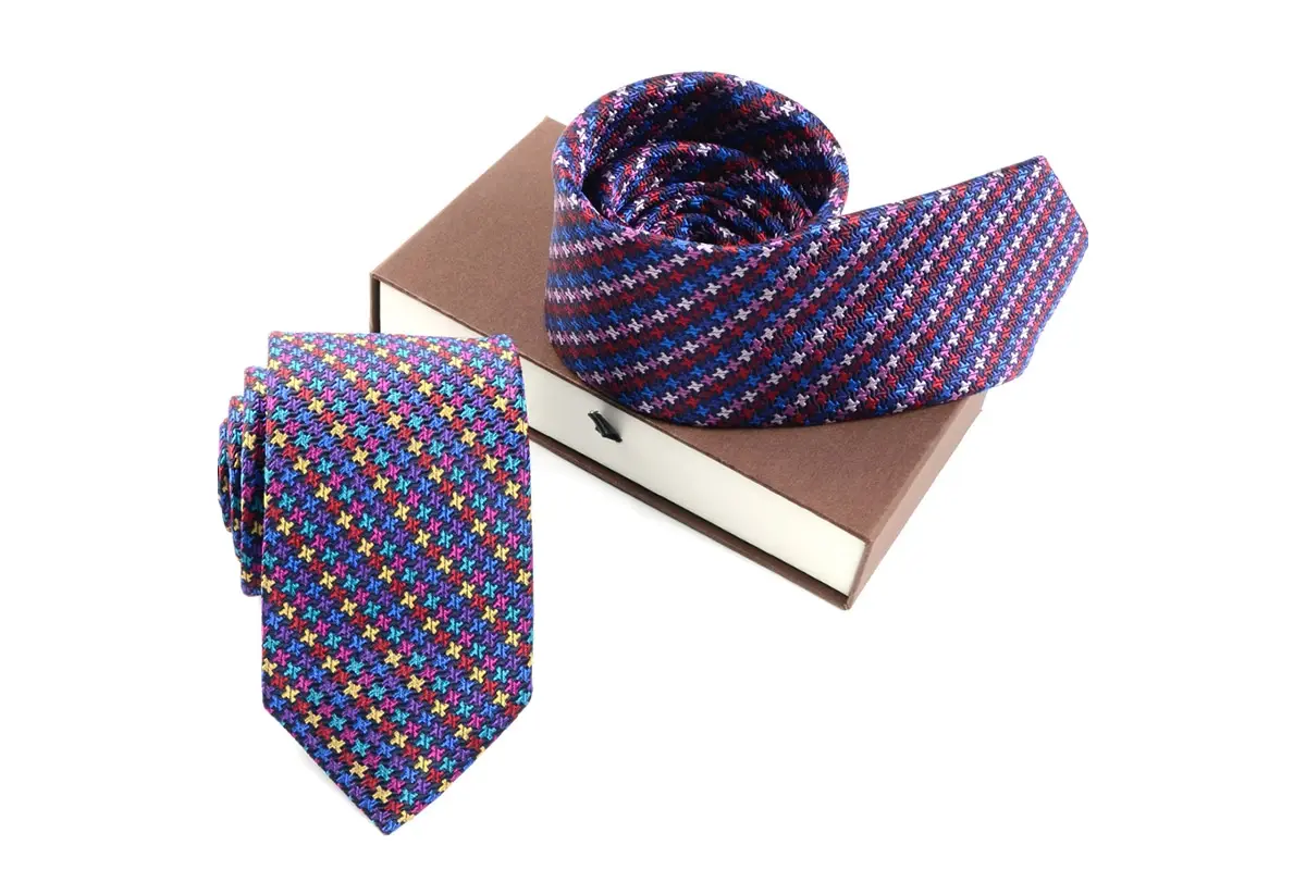 Colorful patterned ties displayed with a cardboard gift box