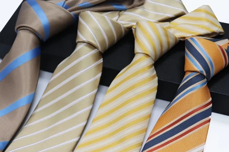 Four knotted ties with different stripe widths and color combinations