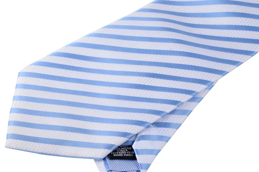 Reverse of a light blue striped tie showing the tip, seam and small label