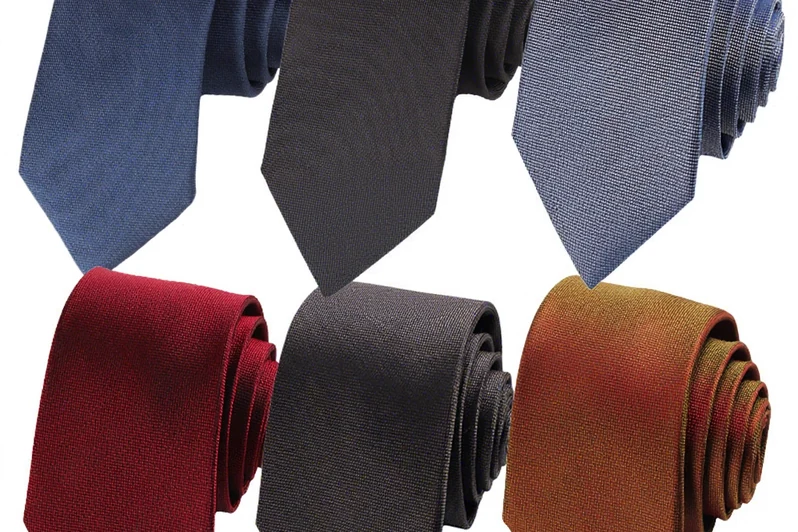 Six rolled ties in blue, black, burgundy, gray and gold tones