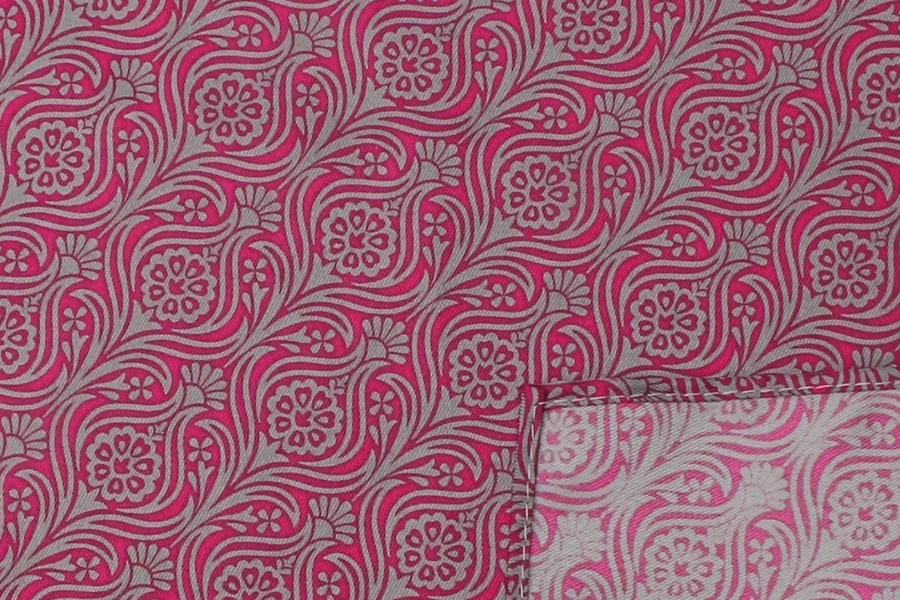Pink and gray paisley fabric with a folded corner showing the reverse