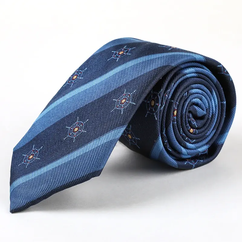 A rolled blue tie with diagonal bands and small repeating motifs.