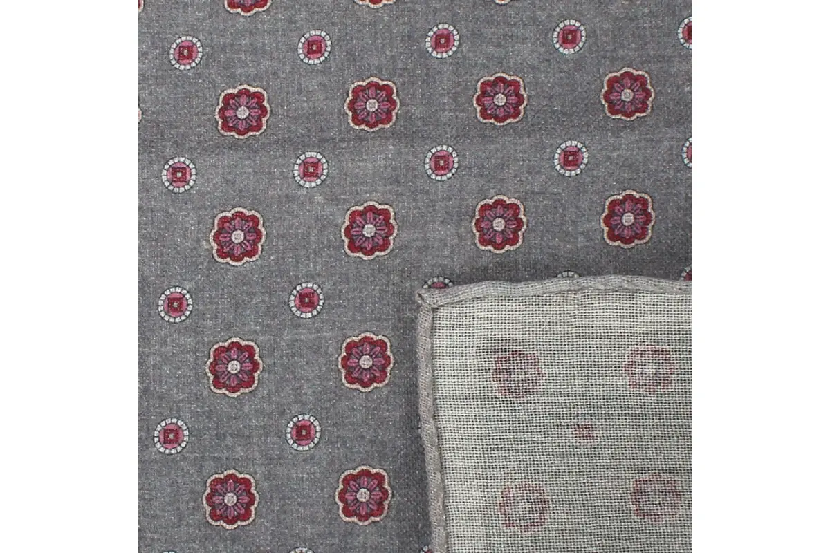 Gray patterned fabric showing its face and reverse.