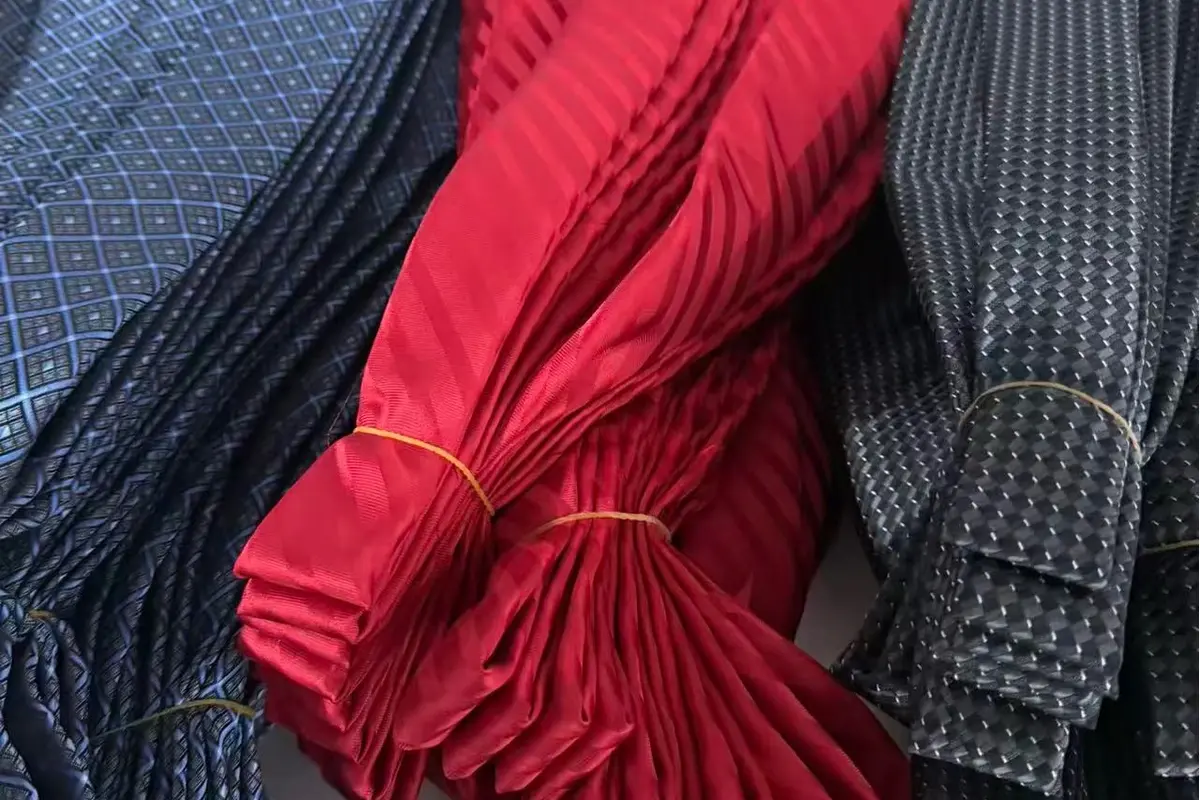 Bundles of red, blue and gray patterned ties.