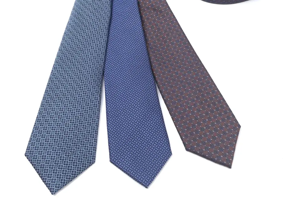 Blue and brown neckties with small repeating patterns.