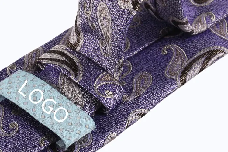 Purple paisley necktie with a sewn label marked LOGO.