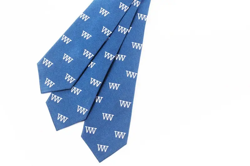 Blue neckties with repeating white letter motifs.
