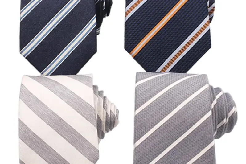 Four striped neckties in navy and light gray.