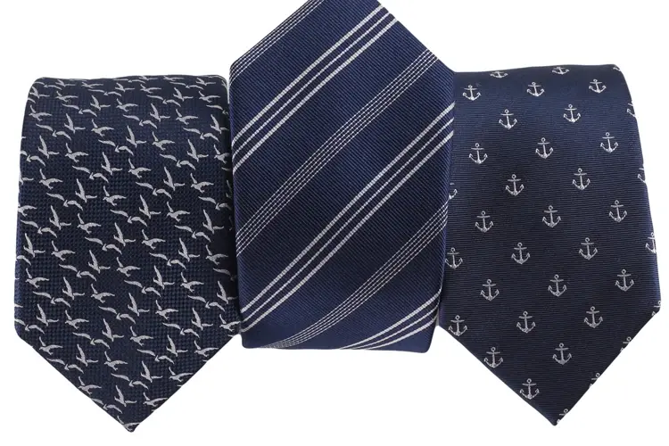 Navy neckties with bird, stripe and anchor patterns.