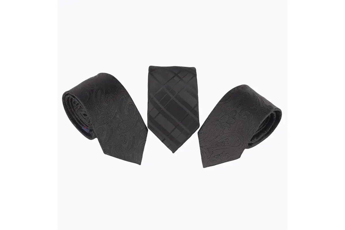 Three black ties with tonal paisley, checked and floral patterns.