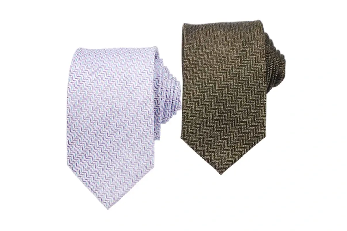 Two ties showing a pale textured pattern and an olive-brown herringbone surface.
