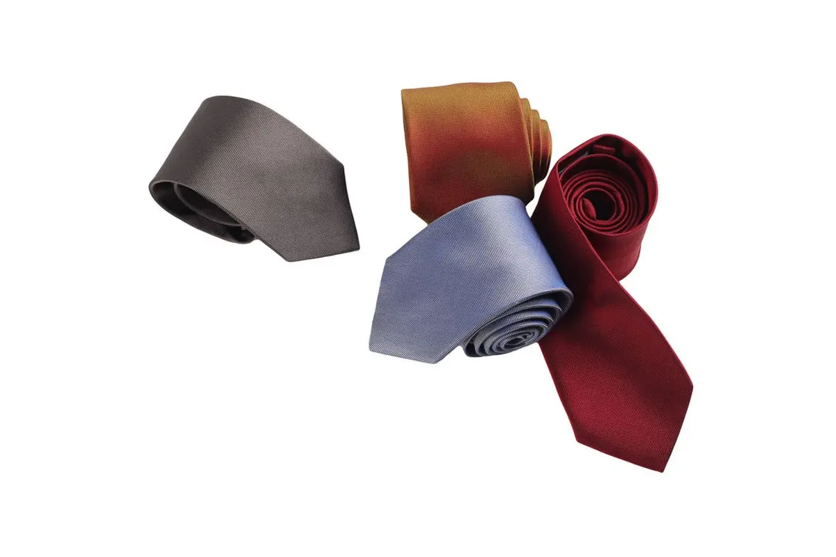 Four rolled ties in gray, gold, pale blue and burgundy.