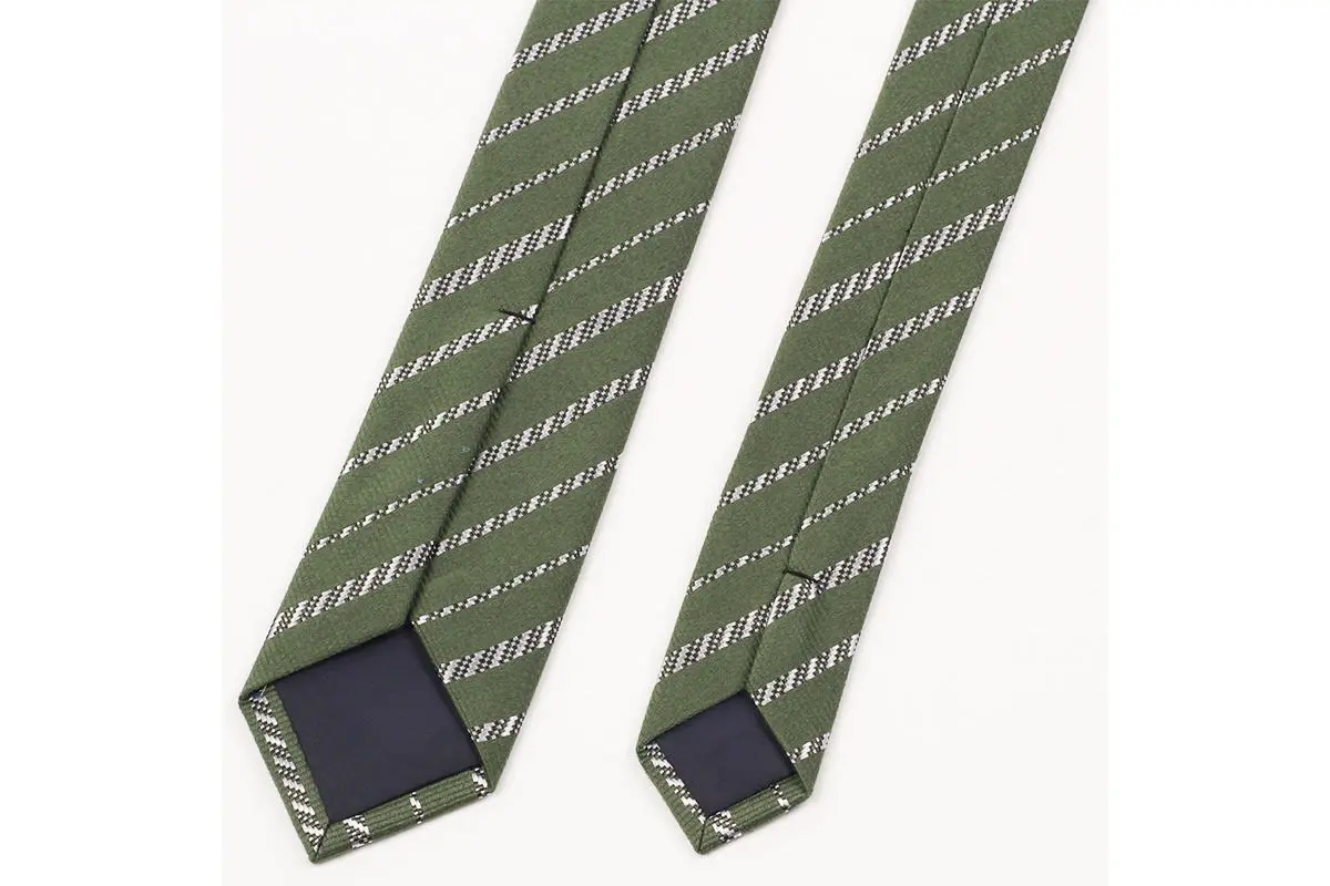 Green tie with fine pale diagonal stripes with reverse seam and dark tipping.