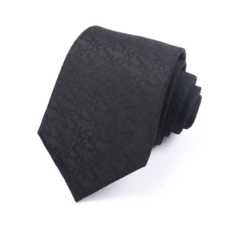 Folded charcoal tie with a subtle dark repeating pattern.