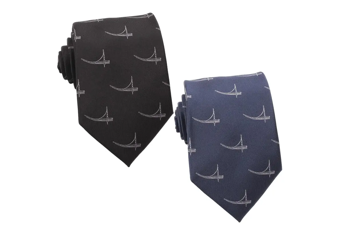 Black and navy ties with repeated pale curved line emblems.
