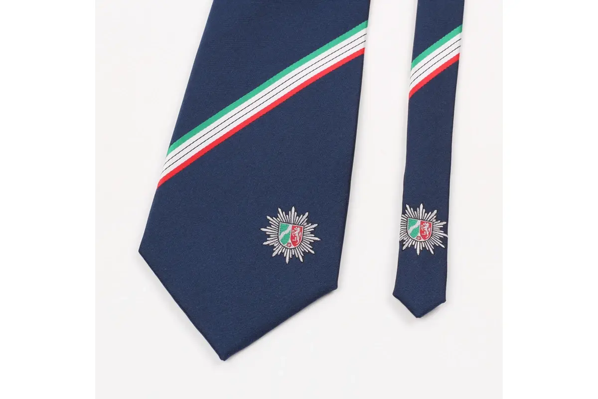 Navy tie blade and tail with matching stripes and multicolor crests.
