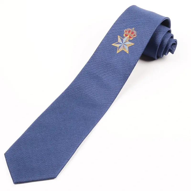 Blue tie blade showing a small gold and red crest.