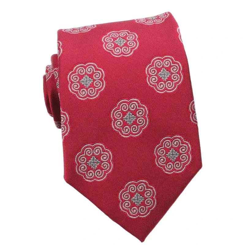 Red tie with repeating pale circular emblems.