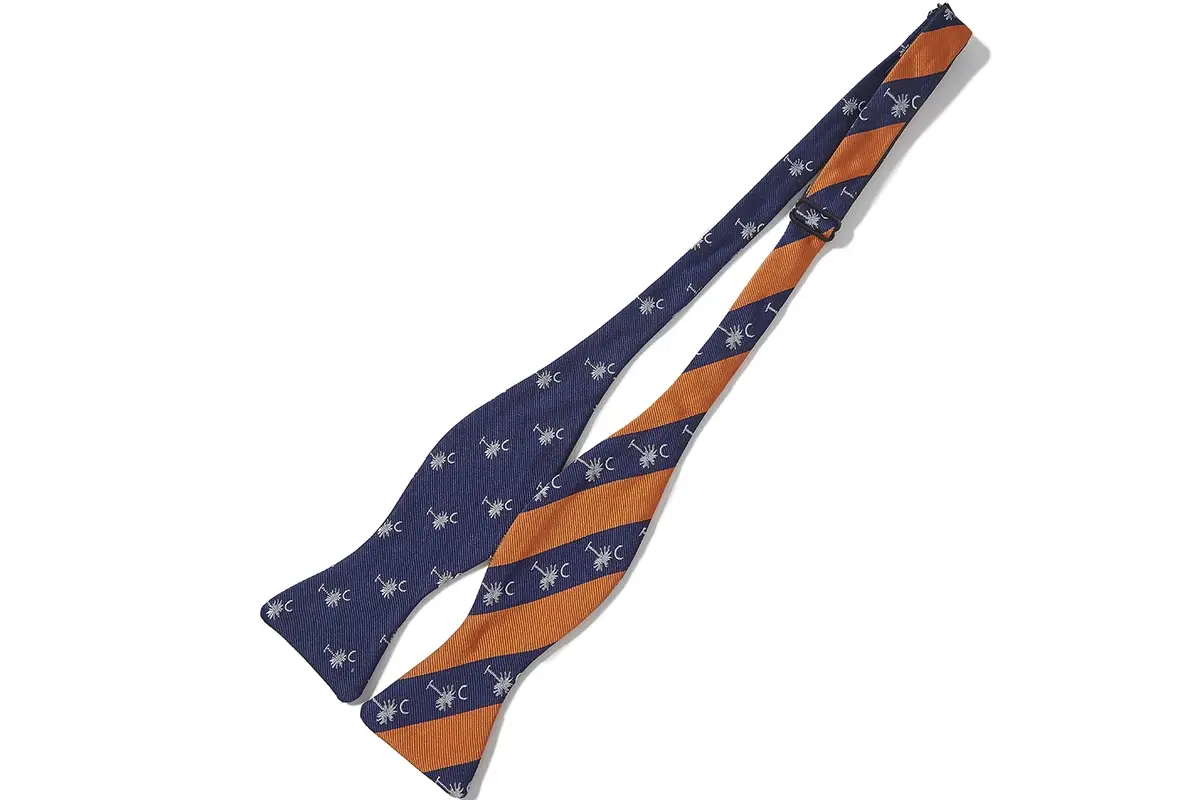 Full tie combining orange and navy diagonal stripes with repeating emblems.