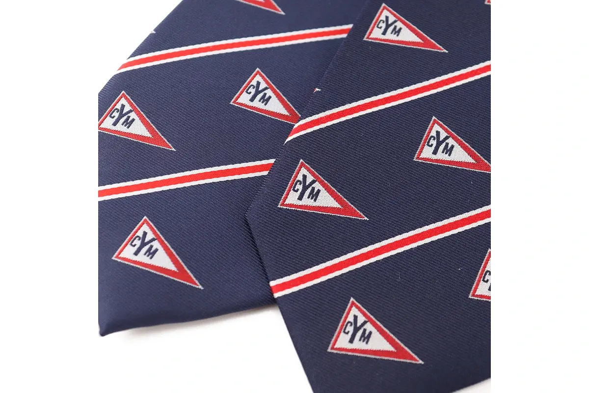 Navy tie fabric with letter emblems and red and white stripes.