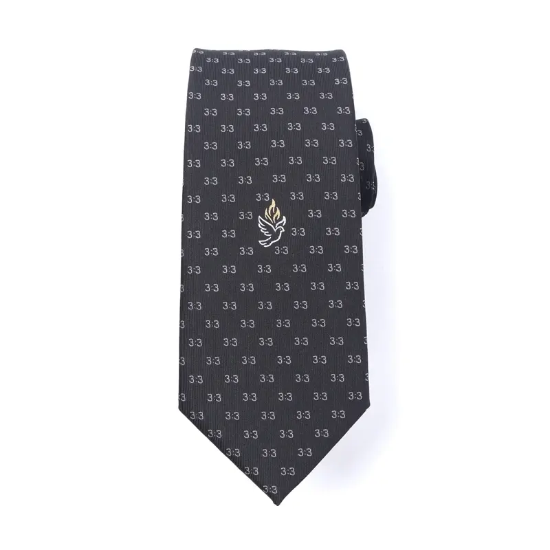 Dark patterned tie with a small placed emblem near the lower blade.