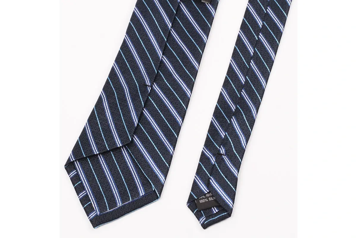 A navy striped tie with center seam, folded edges, tipping and label.