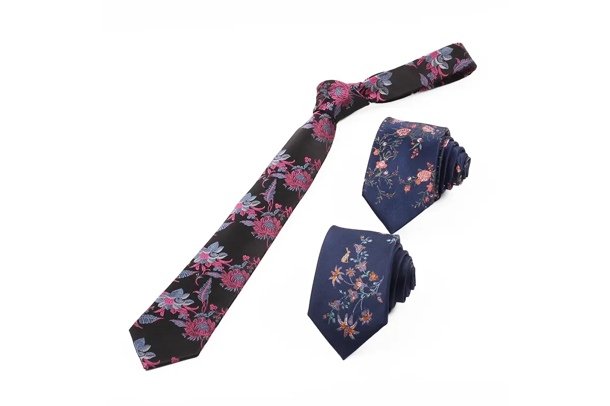 Navy floral tie with a matching bow tie and pocket square.