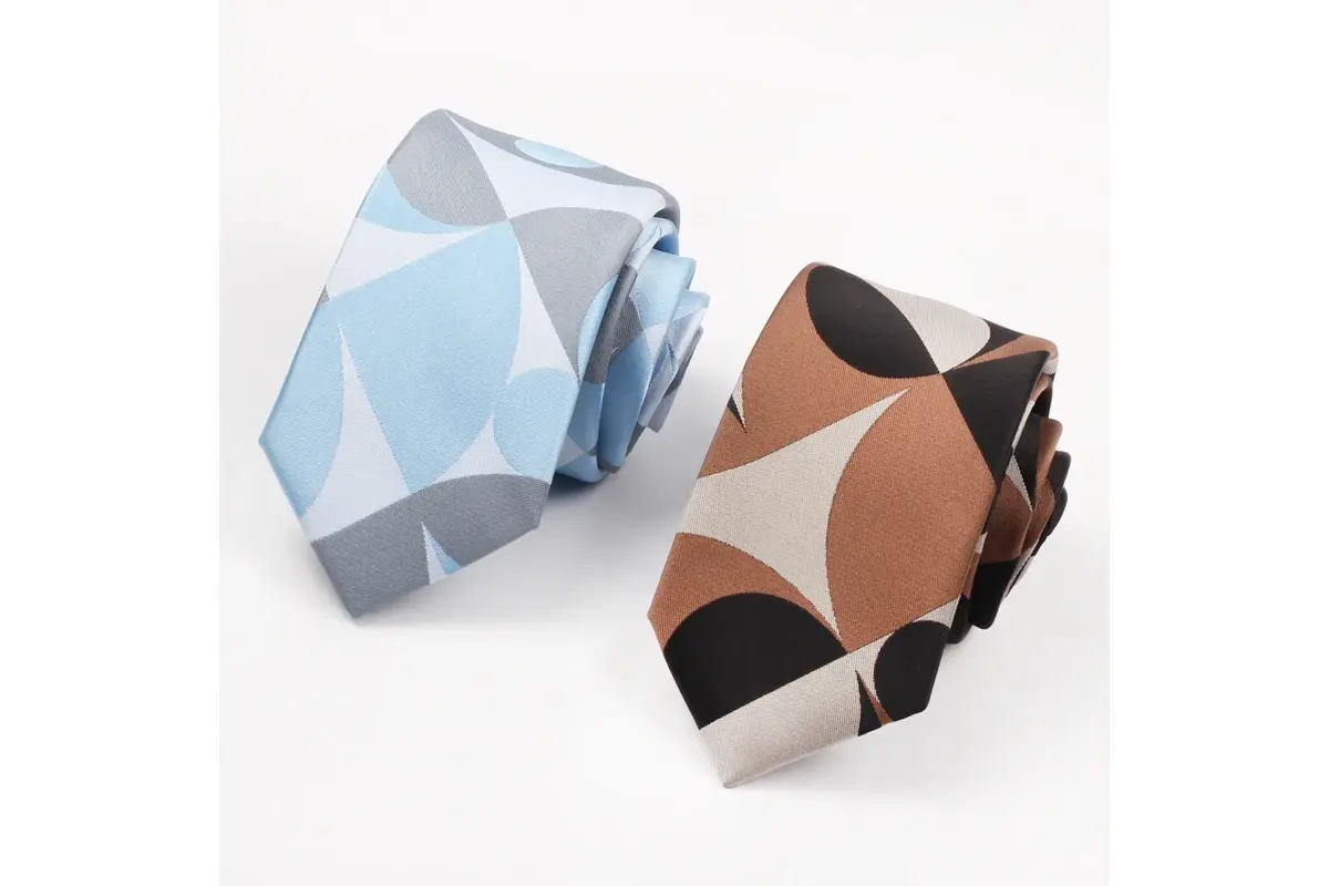 Matching geometric tie designs in pale blue and brown color combinations.