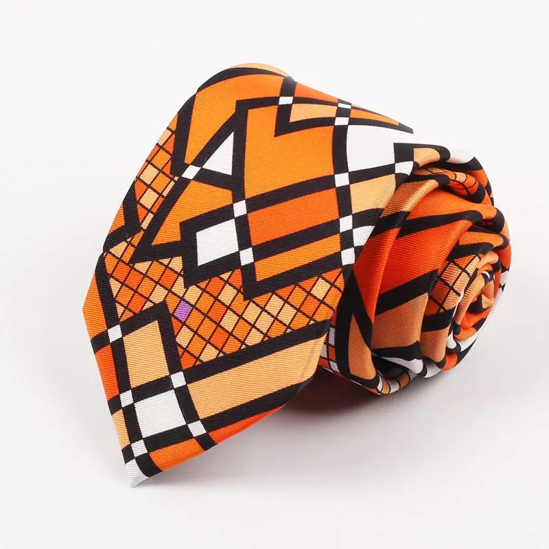 Rolled orange tie with black and white geometric artwork.