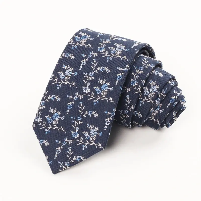 Rolled navy tie with fine pale botanical motifs.