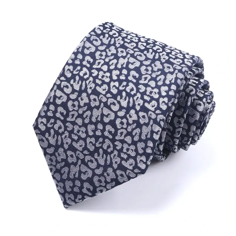 Rolled navy tie with a dense pattern of small pale flowers.