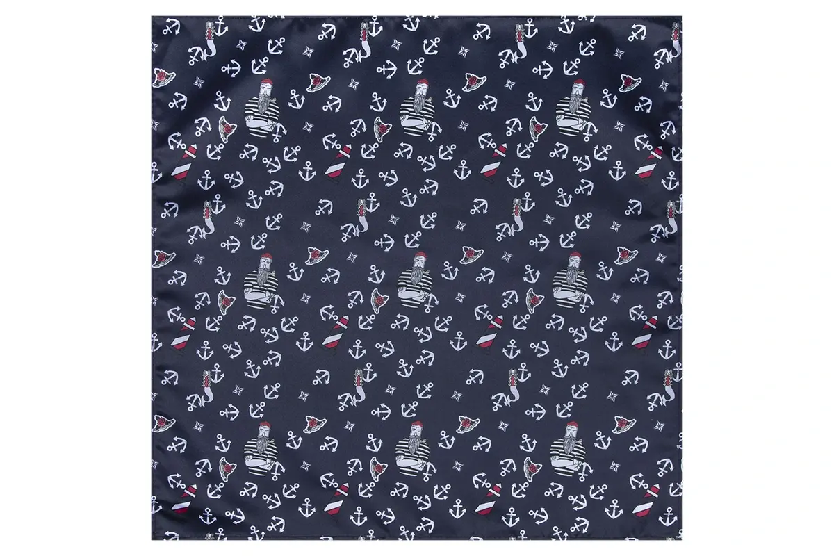 Close-up of pale repeating illustrated motifs on dark blue fabric.