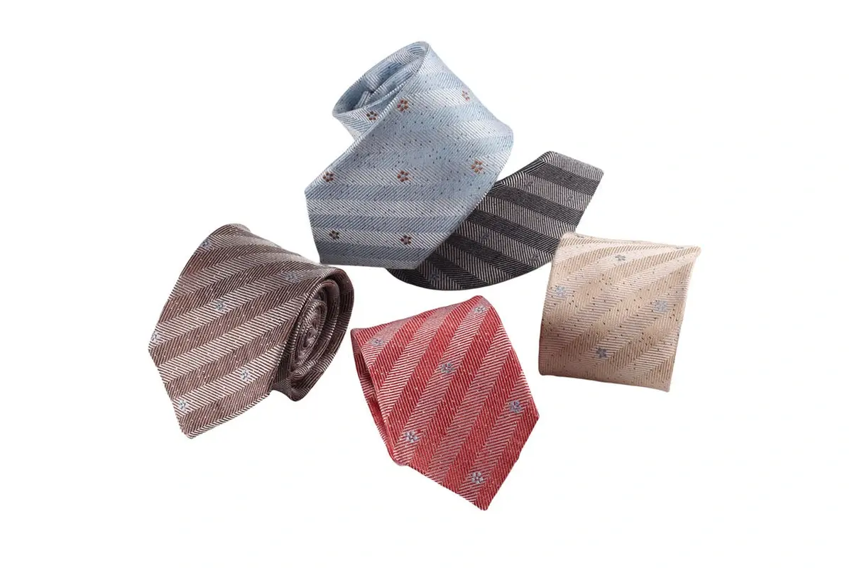 Five ties in pale blue, gray, beige, red and brown with stripes and motifs.
