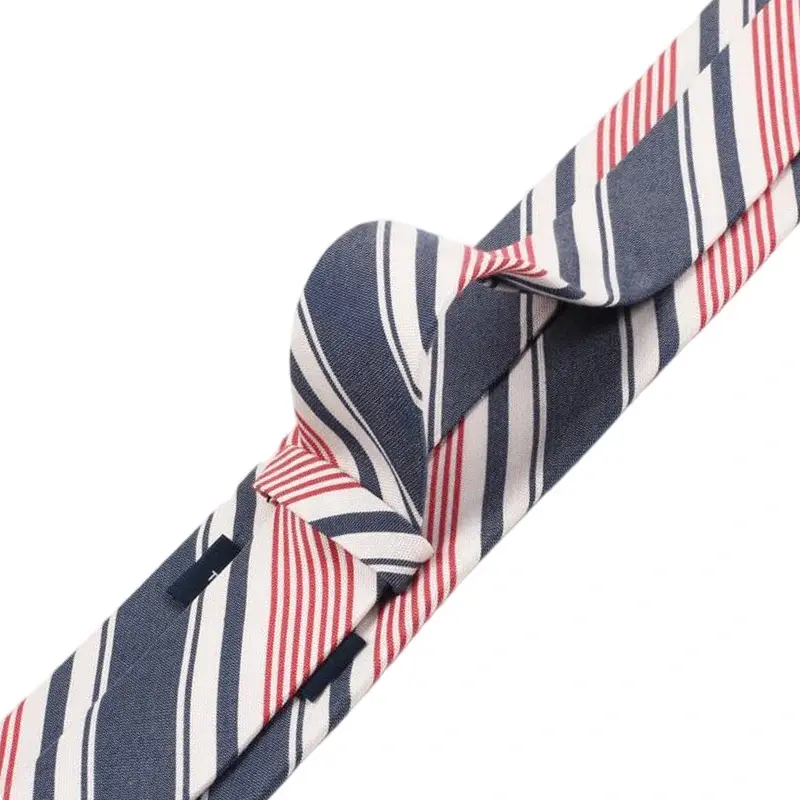 Navy tie with red and white stripes arranged in a loose knot.