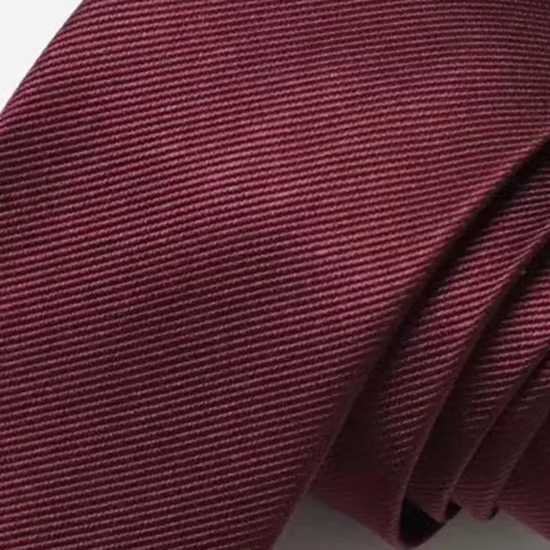 Close-up of rolled burgundy necktie