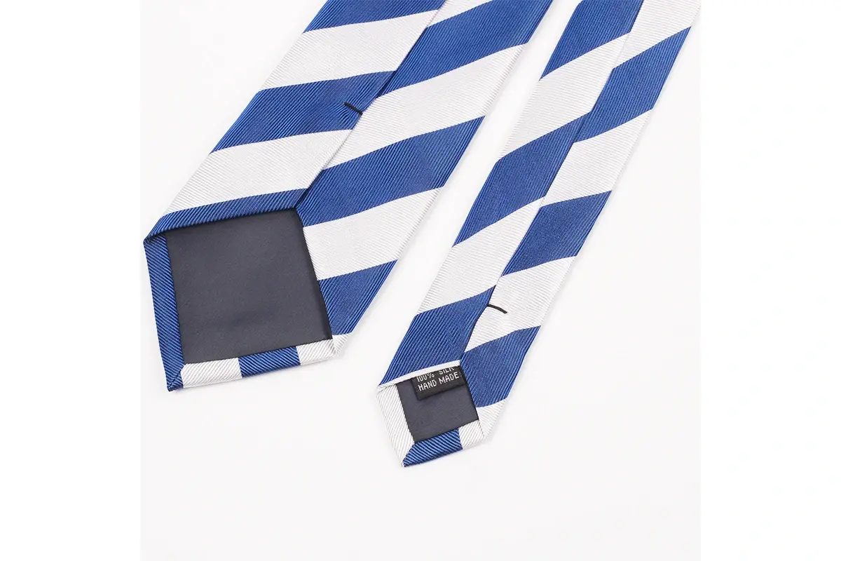 Blue and white striped tie reverse showing dark tipping and a small care label.