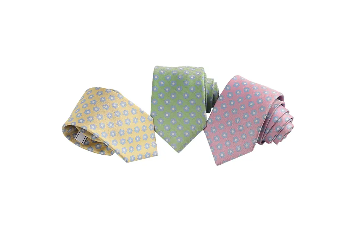 Yellow, green and pink ties with small repeating geometric motifs.