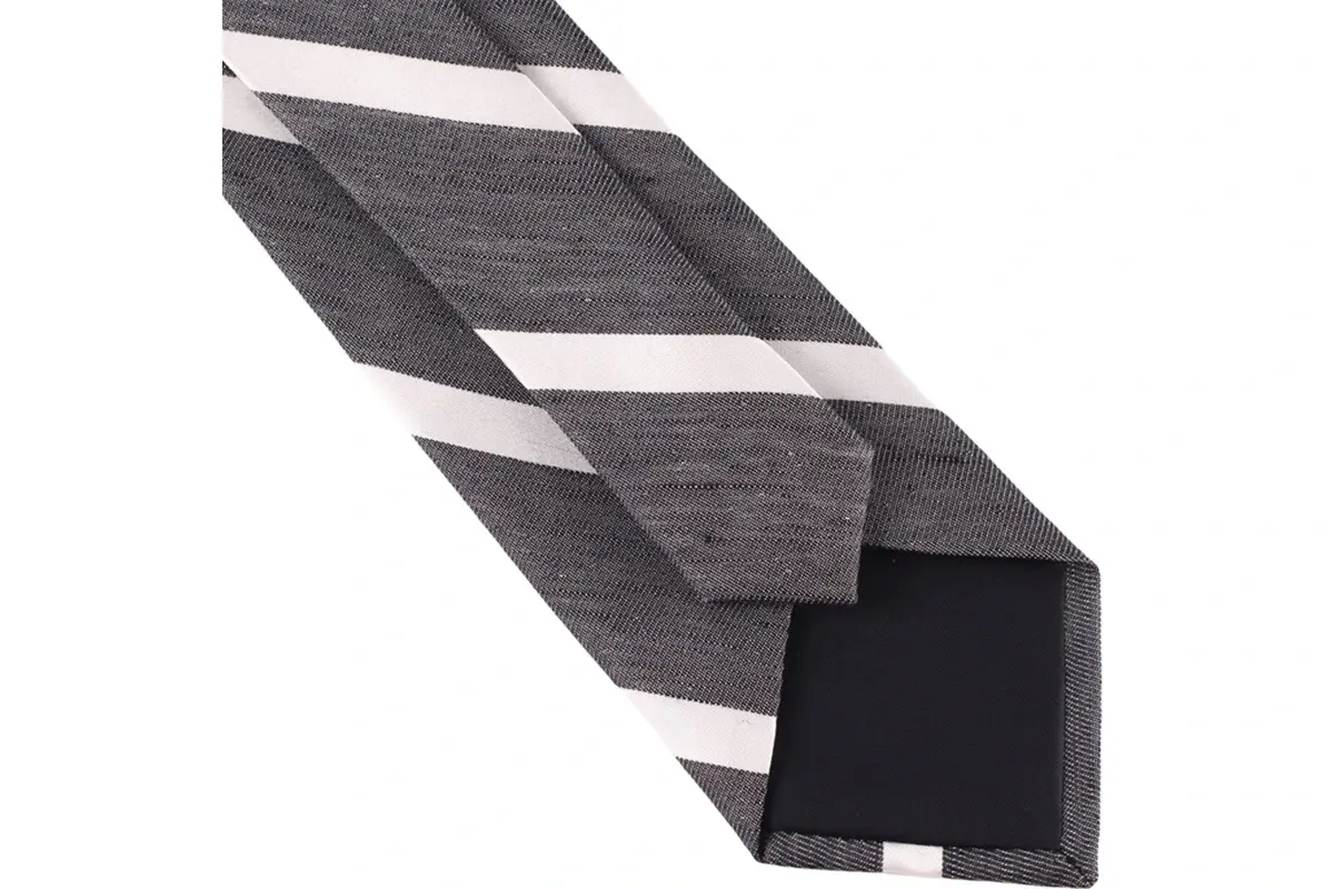 Grey striped tie reverse with folded blade edges, center seam and tipping.