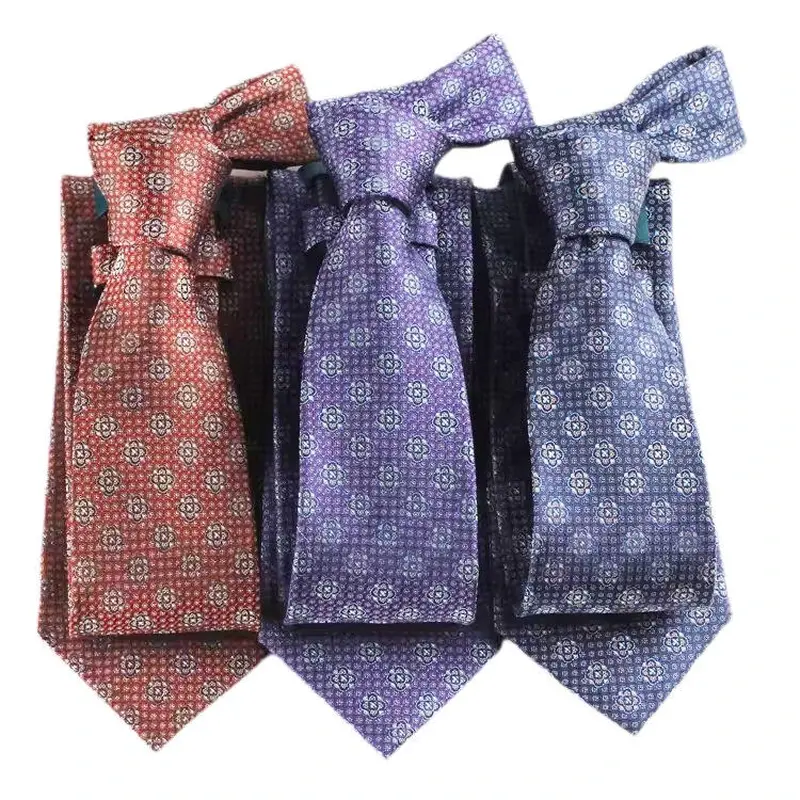 Three knotted ties with repeating patterns in rose, purple and blue.