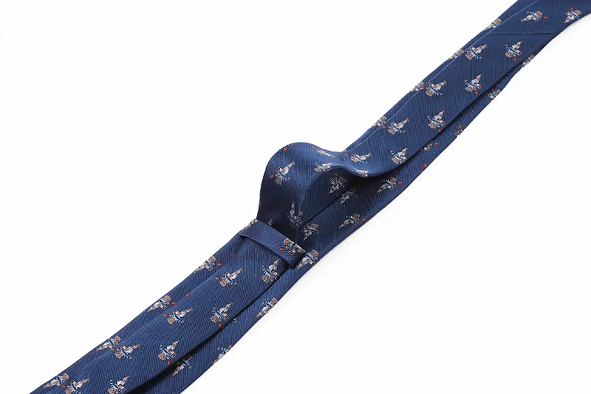 Navy tie with the scale and spacing of repeating animal motifs along the blade.