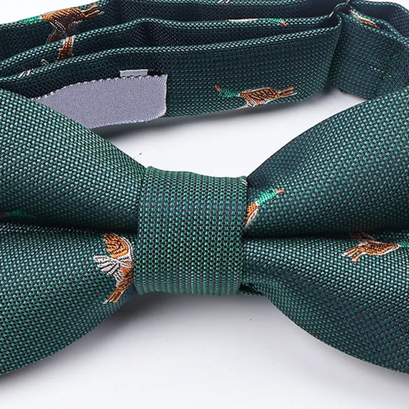 Close-up of green bow tie with small bird motifs