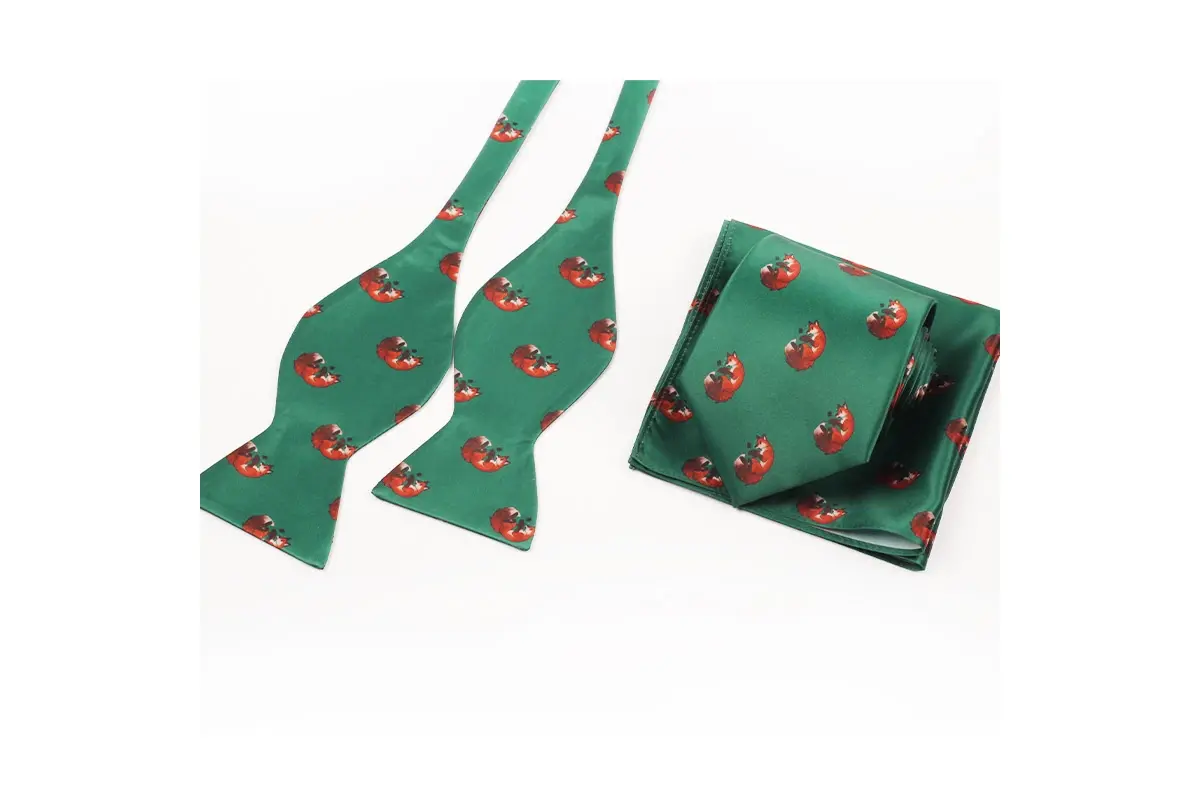 Green self-tie bow tie pieces and pocket square with a repeated red motif.