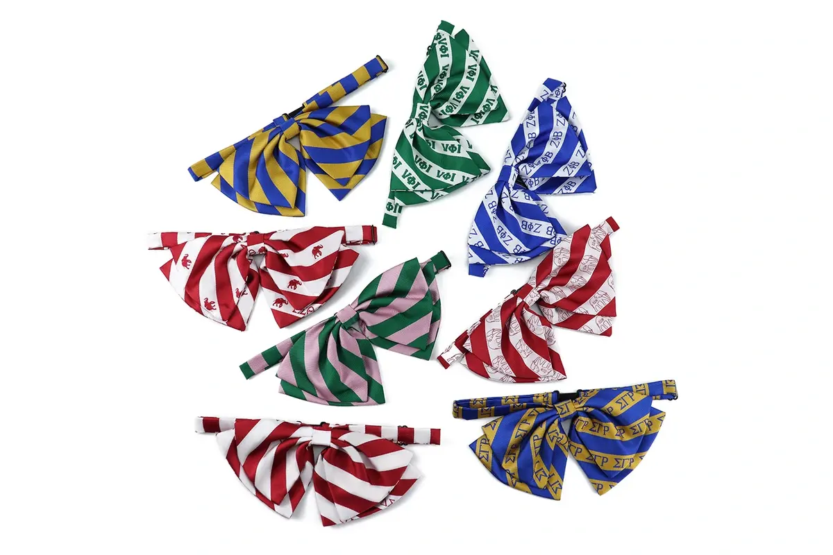 Six self-tie bow ties in coordinated colors with repeated diagonal motifs.