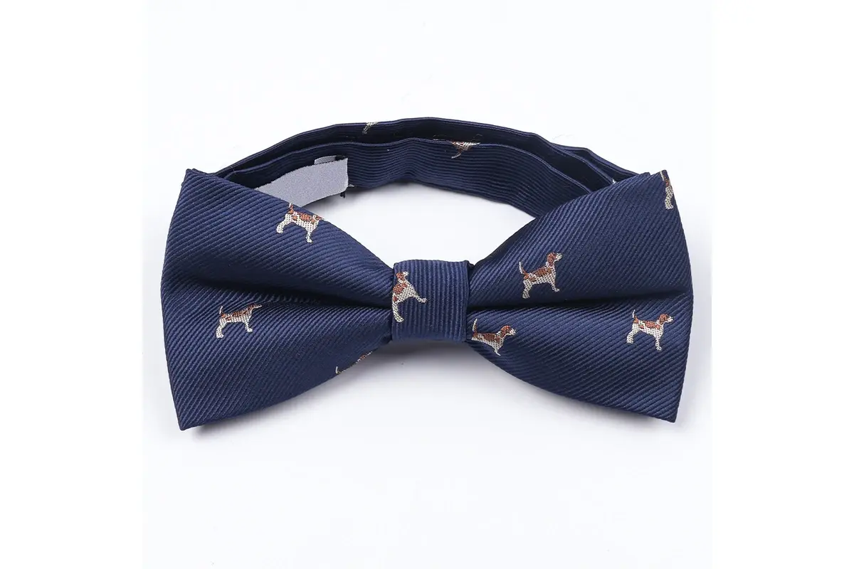 Navy pre-tied bow tie with small dog motifs positioned across wings and knot.