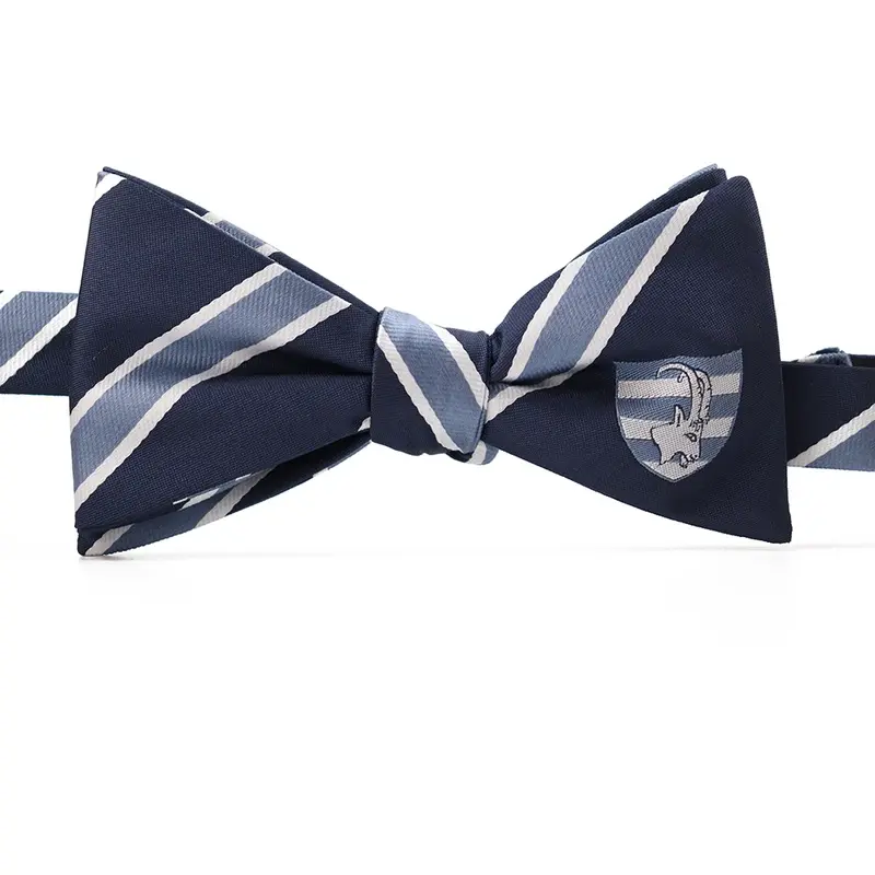 Navy self-tie bow tie with pale blue diagonal stripes and a crest on one wing.
