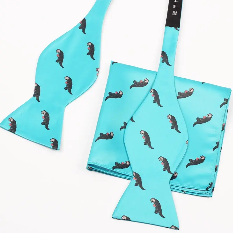 Turquoise self-tie bow tie and pocket square with a repeated dark animal motif.