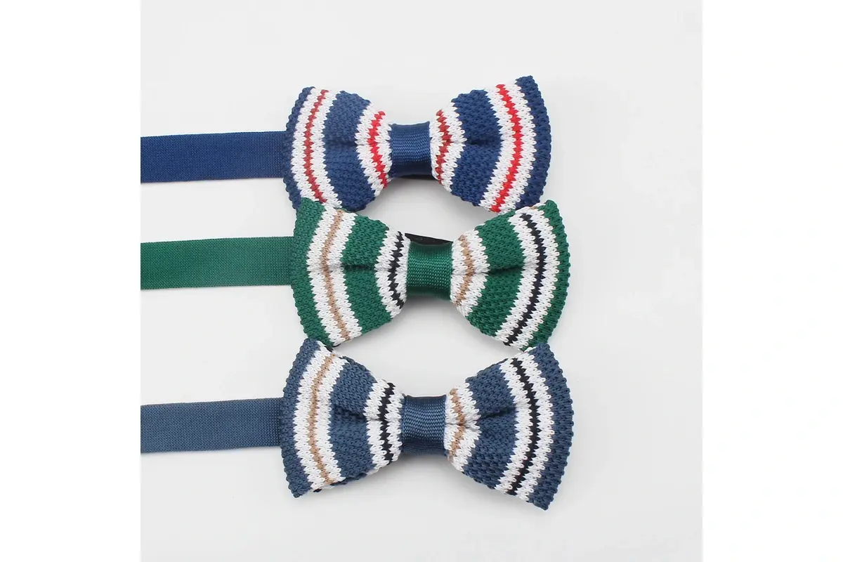 Three pre-tied bow ties with striped wings in blue, green and navy colorways.