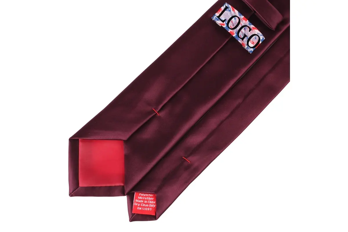 Burgundy tie reverse with logo label, red care label, center seam and tipping.