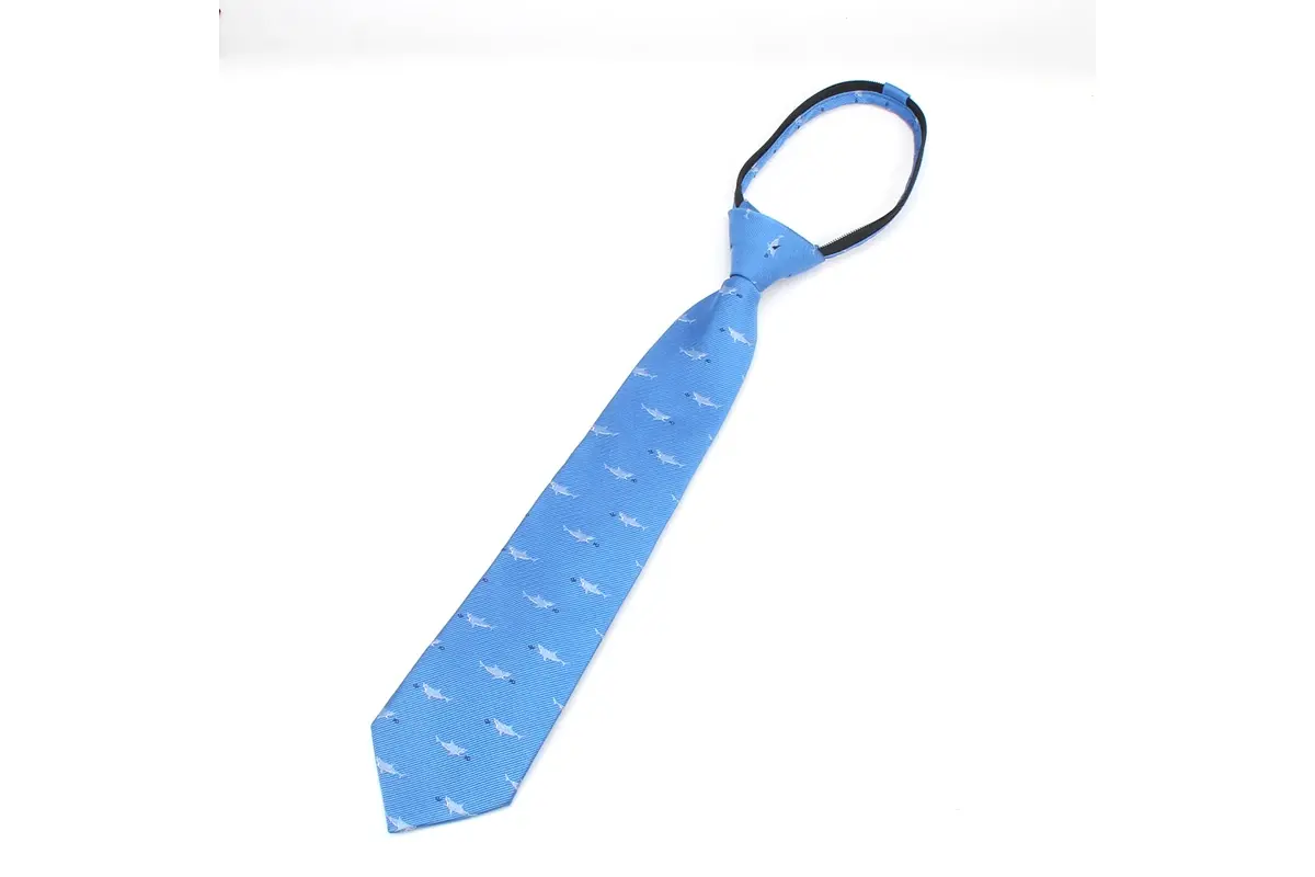 Full light blue knotted tie showing its tapered blade and small pale motifs.